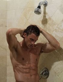A young man having a shower